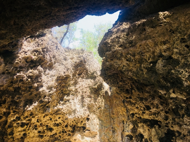 A gap in the rocks and the light streaming in, as seen from inside a cave on Bohol Island (Panglao Island)
